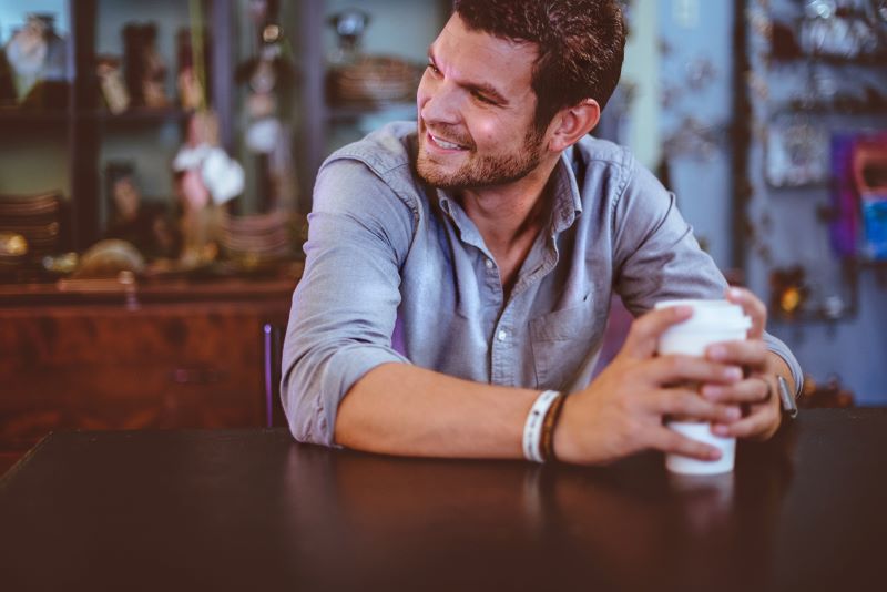 smiling man with cup of coffee