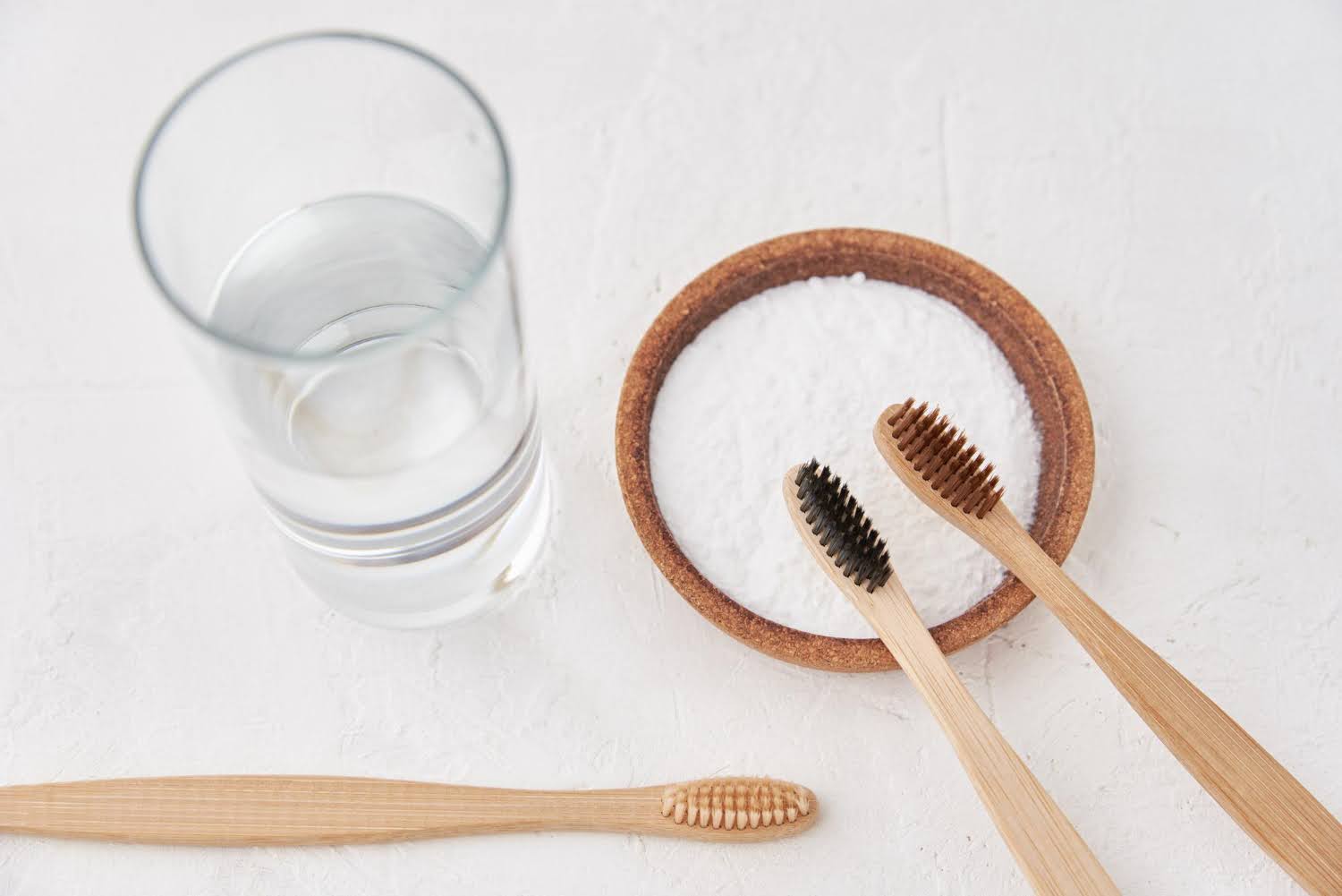bamboo toothbrushes with glass of water and bowl of salt taking care of your teeth sleep dentistry erie