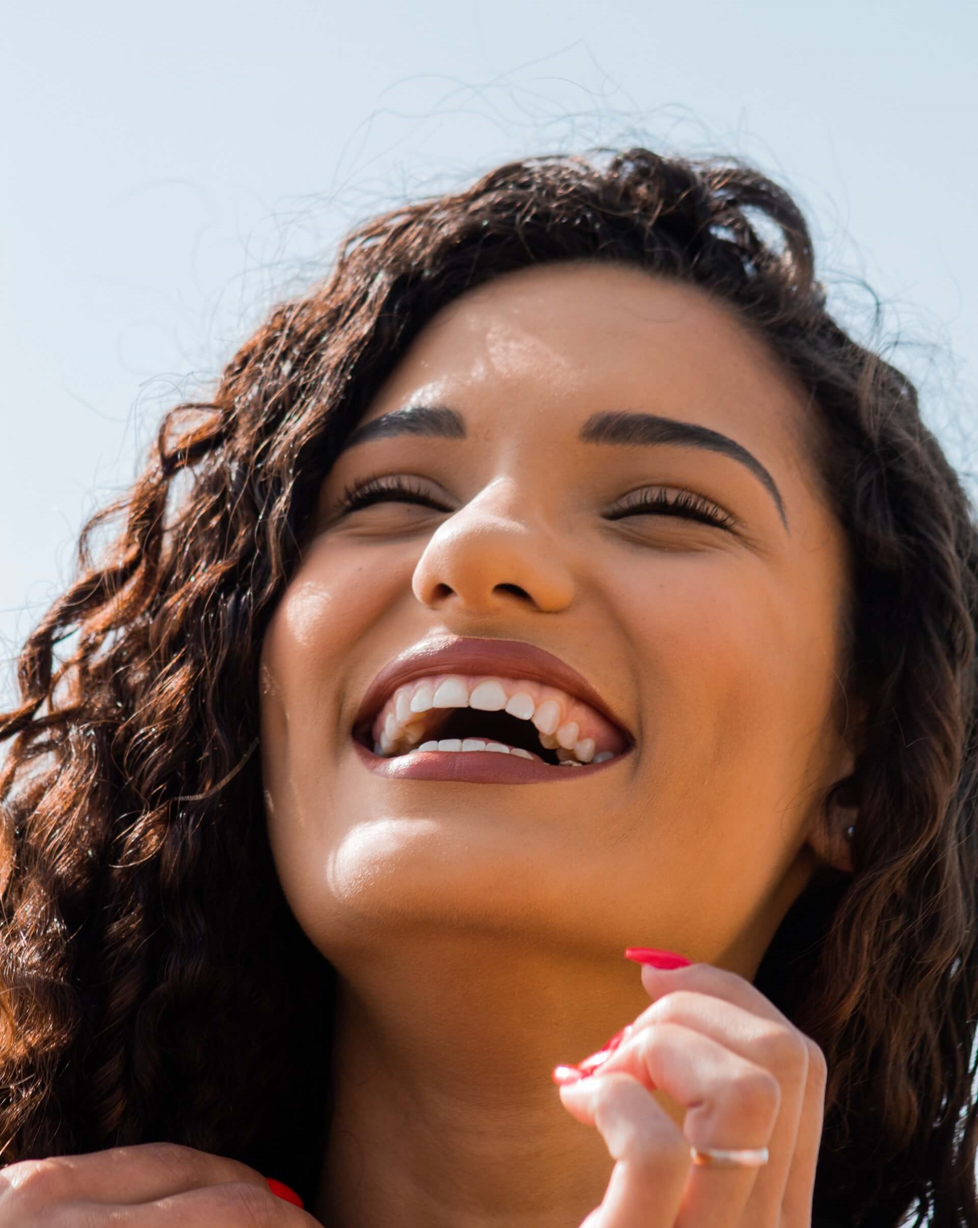 Woman smiling after tooth removal and recovery