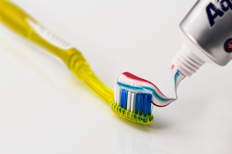 toothpaste squeezed onto toothbrush